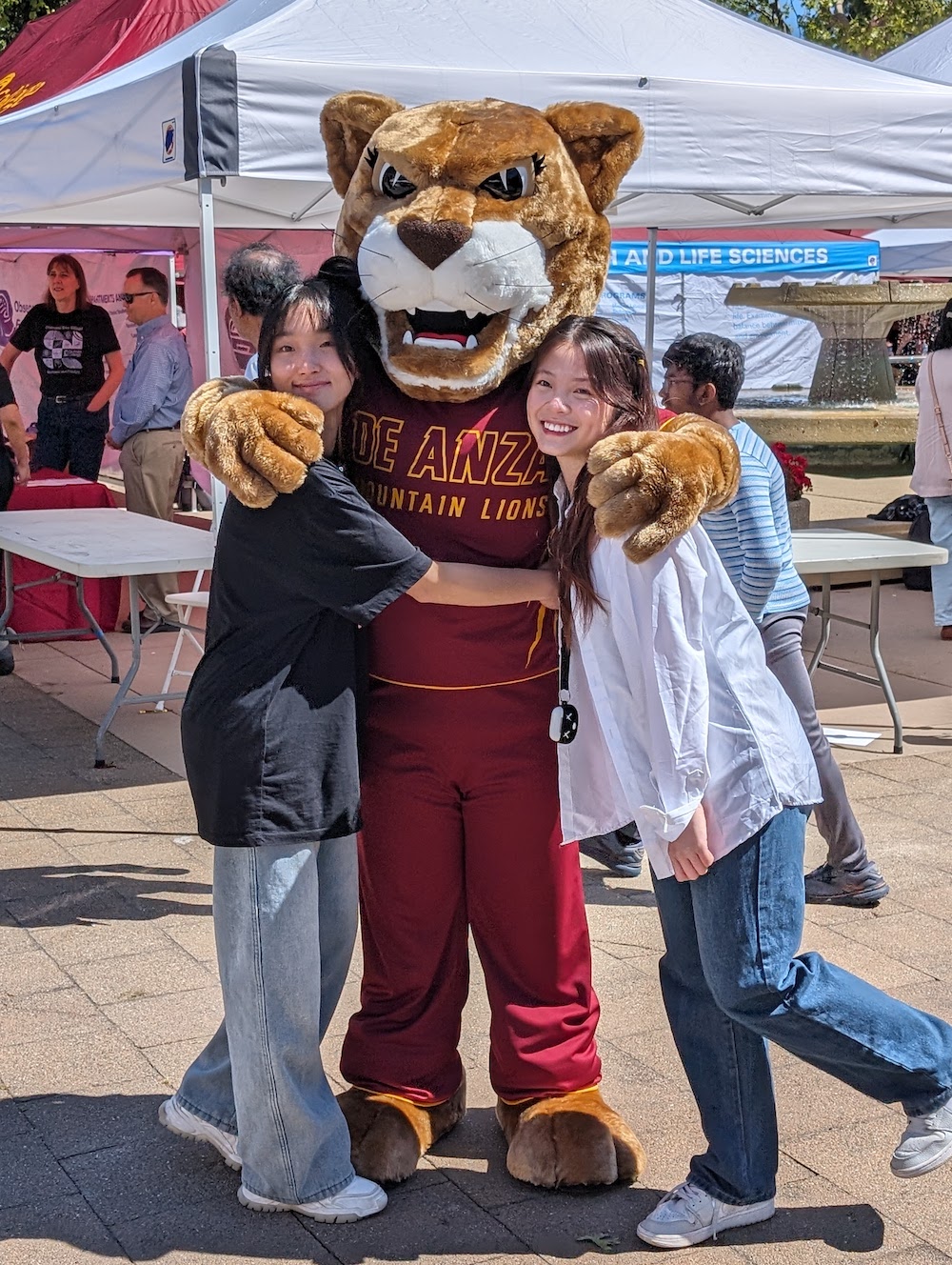 Roary in costume, hugging two girls