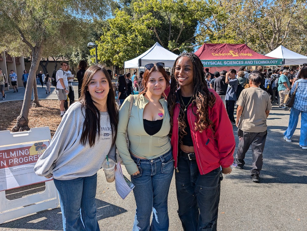 three young women outside Physical Sciences tent