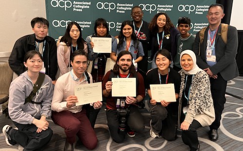 students kneeling with award certificates